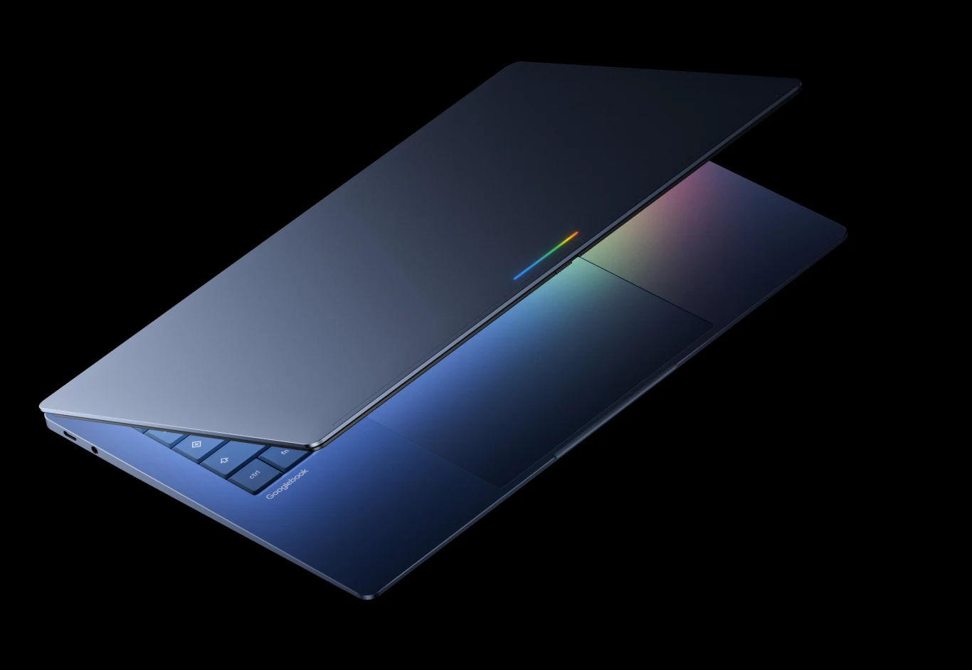 Nowoczesny, częściowo otwarty laptop w ciemnogranatowej obudowie z subtelnym, kolorowym akcentem na klapie oraz widocznymi czarnymi klawiszami klawiatury.