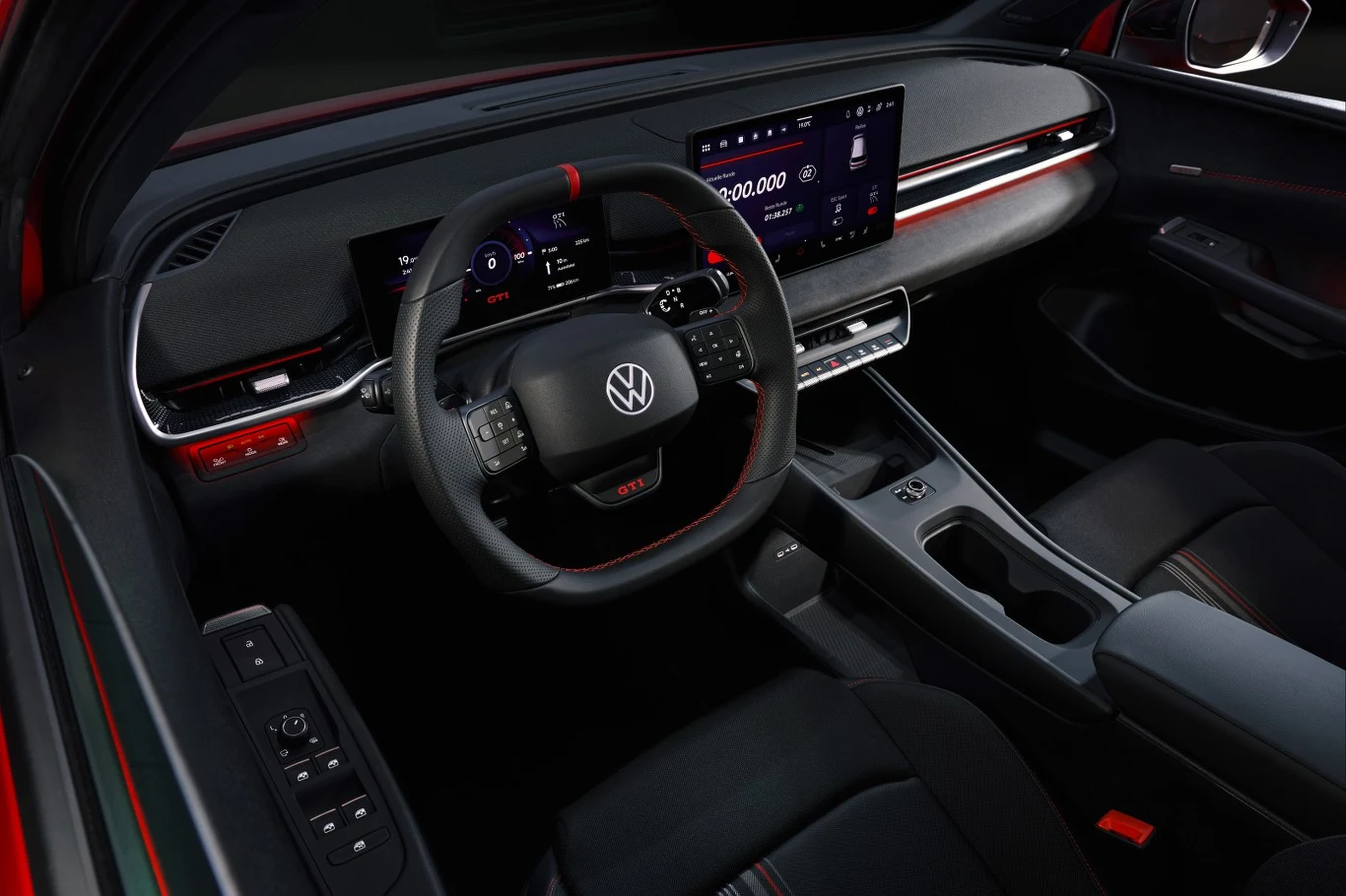 Nowoczesne wnętrze samochodu Volkswagen z cyfrowym kokpitem, dużym ekranem dotykowym na konsoli centralnej, sportową kierownicą i subtelnymi czerwonymi akcentami dekoracyjnymi.