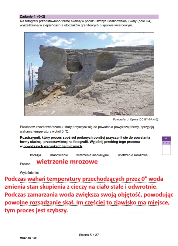 Duża skała o jasnej barwie z charakterystycznymi zagłębieniami i oknem skalnym, wyrzeźbiona przez proces wietrzenia mrozowego.