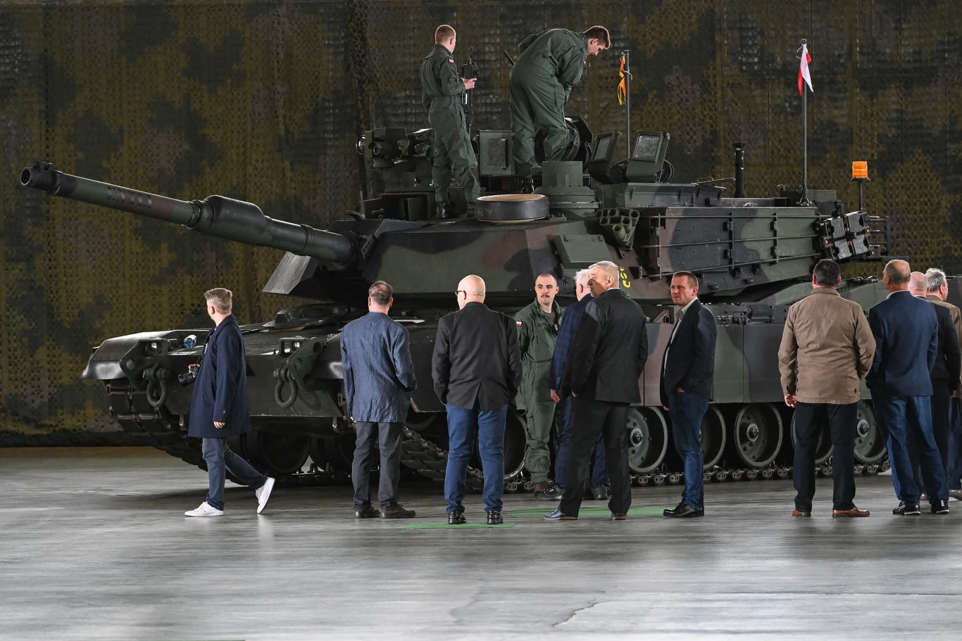 W Dęblinie powstanie jedyne w Europie centrum serwisowania silników czołgów Abrams Mężczyźni w garniturach i mundurach wojskowych stojący przy czołgu Abrams w Dęblinie, kilku żołnierzy na wieży.