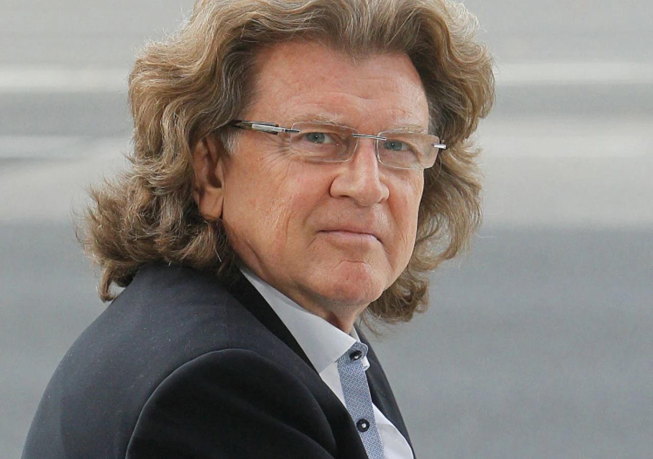 Zbigniew Wodecki Zbigniew Wodecki w eleganckim garniturze i okularach spogląda w stronę obiektywu.