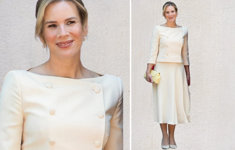 Stylizacja Marty Nawrockiej wywołała dyskusję Kobieta w eleganckim kremowym komplecie składającym się z długiej spódnicy i bluzki z ozdobnymi guzikami, trzymająca żółtą kopertówkę, z delikatnym makijażem i upiętymi blond włosami.