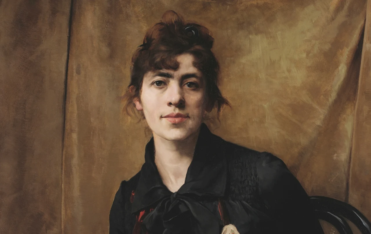 Anna Bilińska-Bohdanowiczowa, fragment autoportretu z 1887 roku Anna Bilińska-Bohdanowiczowa na autoportrecie z 1887 roku; ciemne włosy, czarna suknia, tło z brązowej tkaniny.