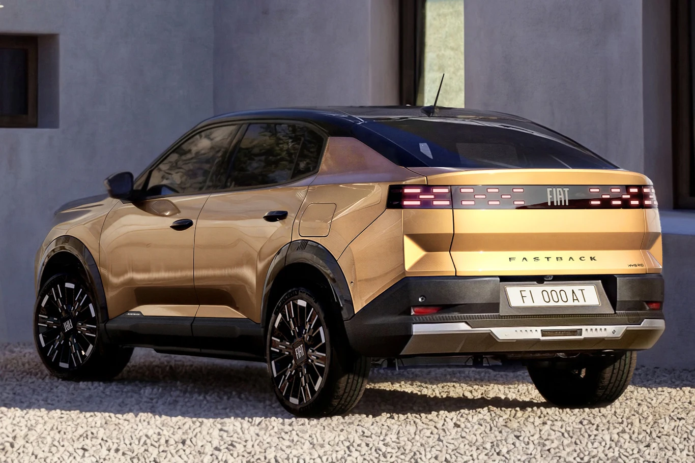 Złoty SUV marki Fiat z przyciemnianymi szybami, czarnym dachem i efektownymi tylnymi lampami LED, zaparkowany na żwirowej nawierzchni przy nowoczesnym budynku.