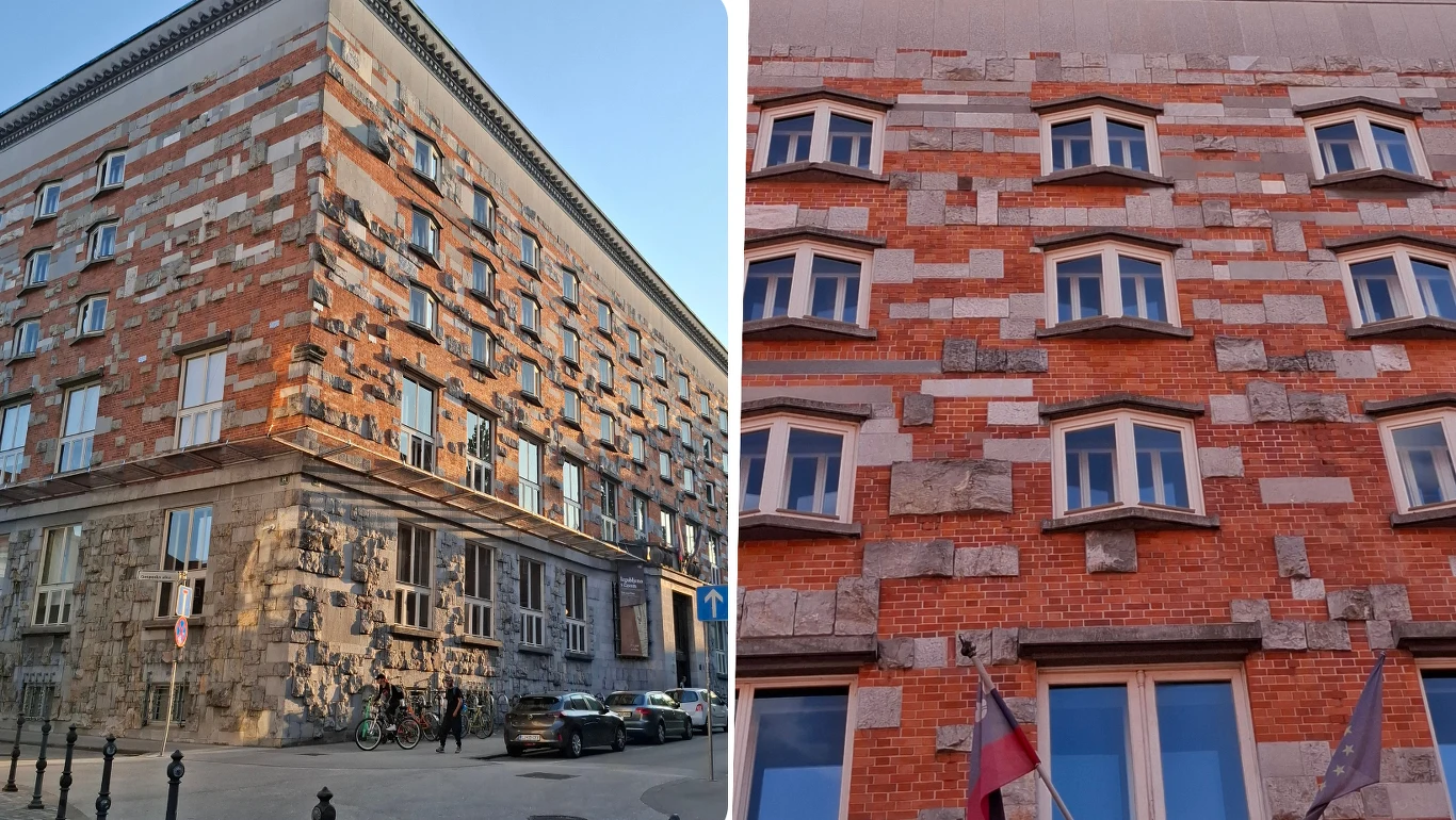 Fasada budynku z nieregularnym układem cegieł i bloków kamienia, liczne okna rozmieszczone symetrycznie, przed wejściem widoczne flagi narodowe.
