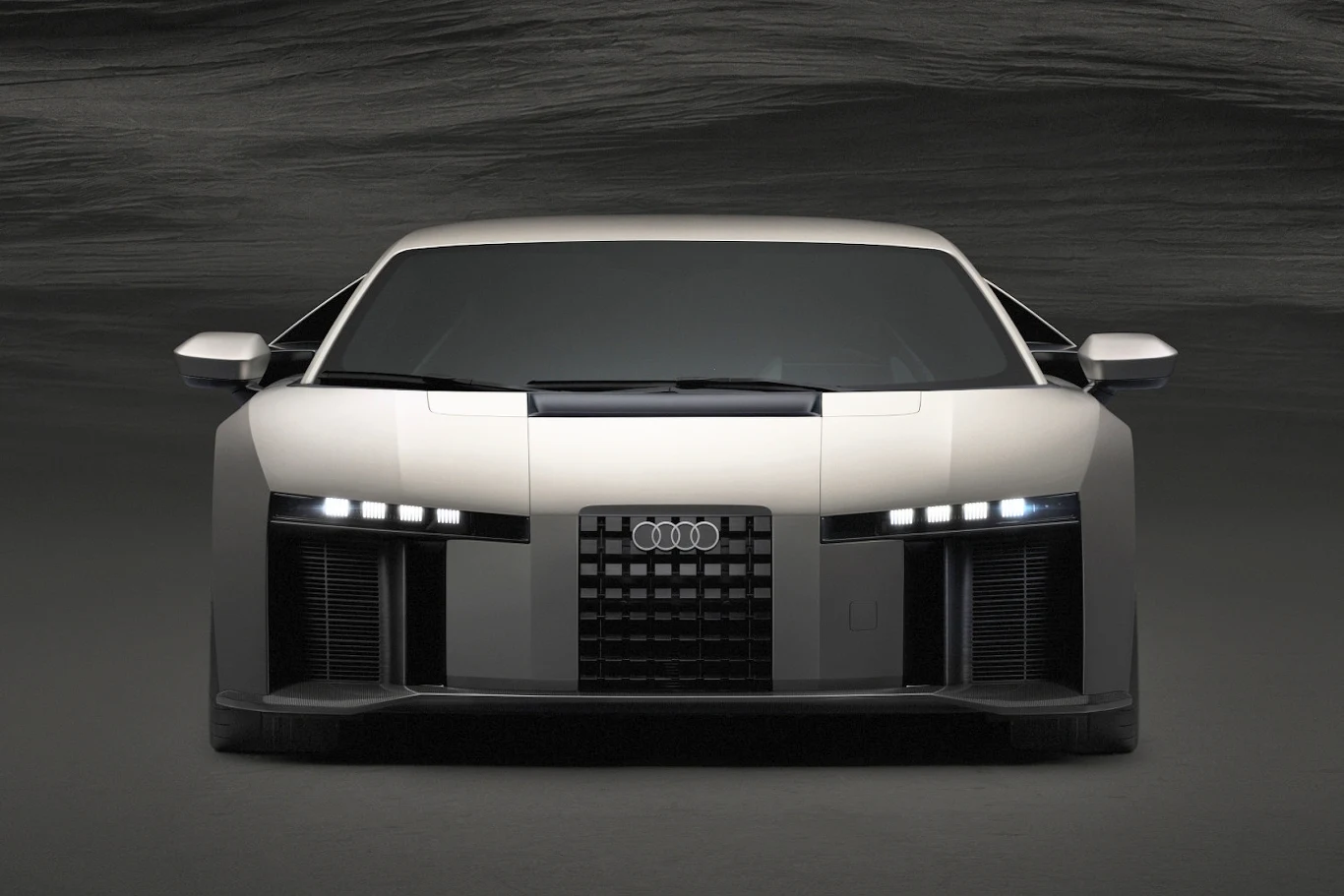 Nowoczesny samochód sportowy marki Audi o agresywnej stylistyce, szerokim przednim grillu, wąskich światłach LED i aerodynamicznej sylwetce.