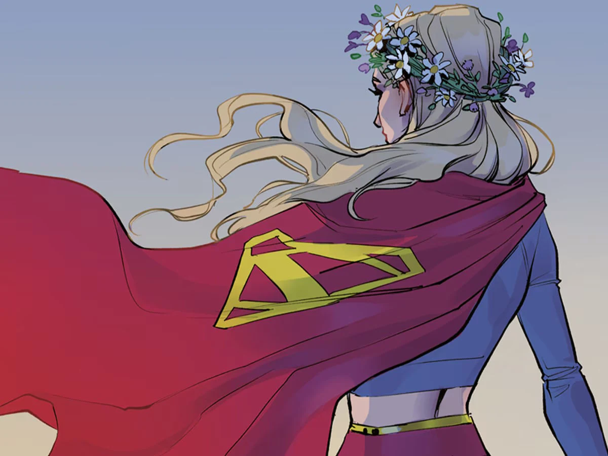 Supergirl: Świat Supergirl w czerwonej pelerynie, niebieskim kostiumie, złotym pasie i z wiankiem z kwiatów na głowie