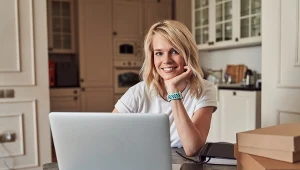 Contented young woman smiling at the table