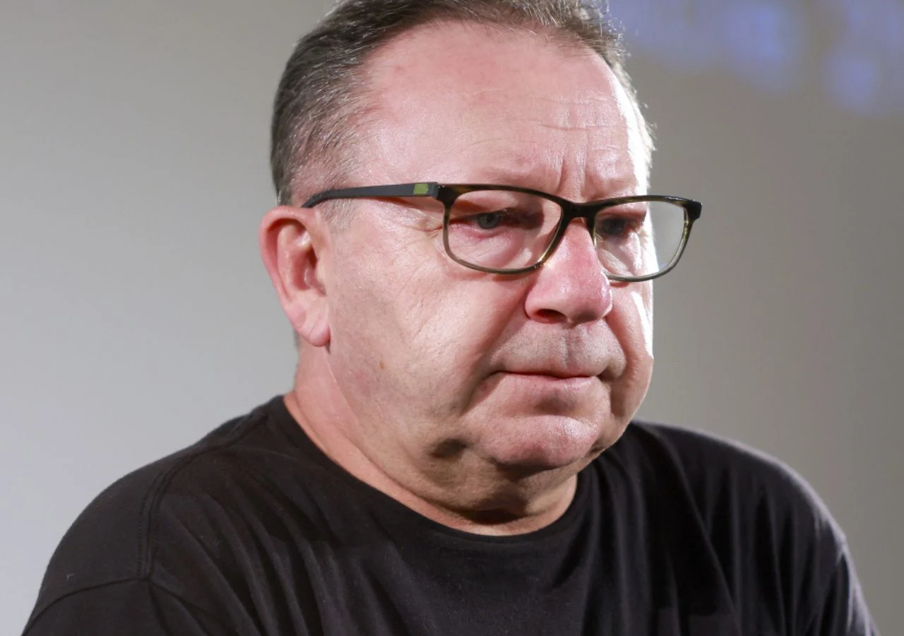 Zbigniew Zamachowski Portret Zbigniewa Zamachowskiego w czarnej koszulce na jasnym tle.