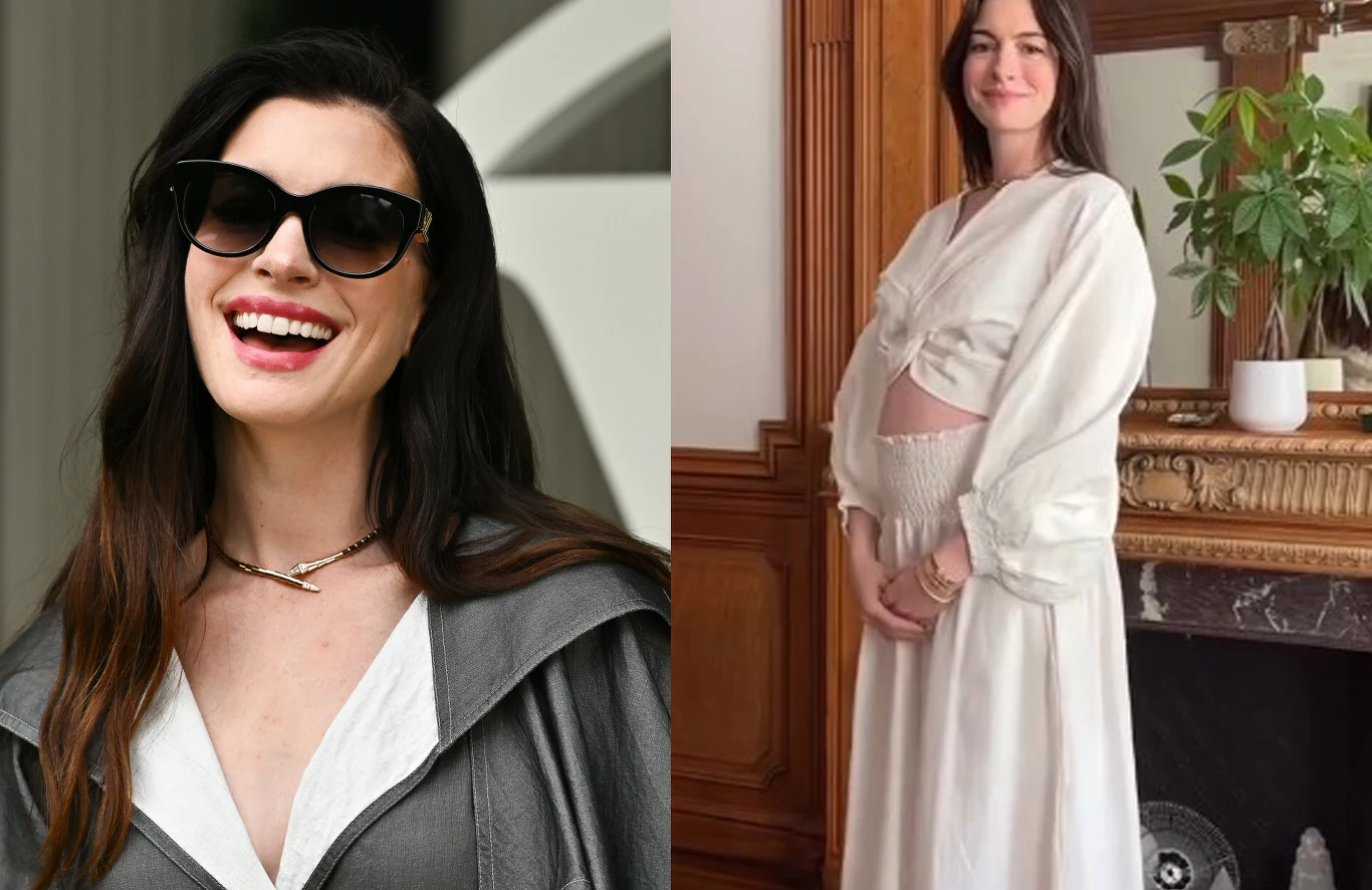 Anne Hathaway pokazała ciążowe krągłości Kobieta z długimi, ciemnymi włosami, po lewej stronie uśmiechnięta w dużych okularach przeciwsłonecznych, po prawej stronie ubrana na jasno, z widocznym ciążowym brzuchem, stojąca przy kominku i roślinie w doniczce.