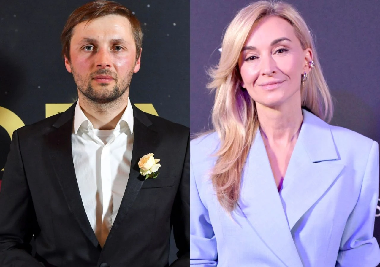 Andrzej Bargiel i Martyna Wojciechowska Mężczyzna w eleganckim, czarnym garniturze z białą koszulą oraz białą różą w butonierce obok kobiety z długimi blond włosami, ubranej w jasnoniebieską marynarkę.