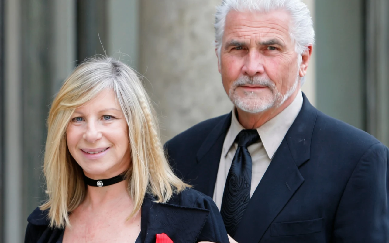 Kobieta o blond włosach w czarnej bluzce z czerwonym akcentem i chokerem na szyi stoi obok mężczyzny z siwymi włosami i brodą, ubranego elegancko w czarny garnitur i krawat.