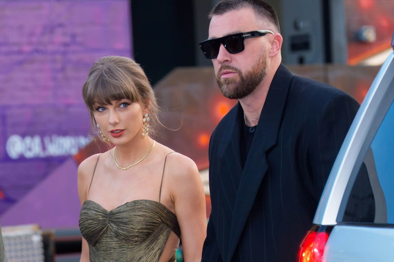Taylor Swift i Travis Kelce są już po ślubie Taylor Swift w złotej sukni i Travis Kelce w czarnym garniturze z okularami przeciwsłonecznymi idą obok samochodu