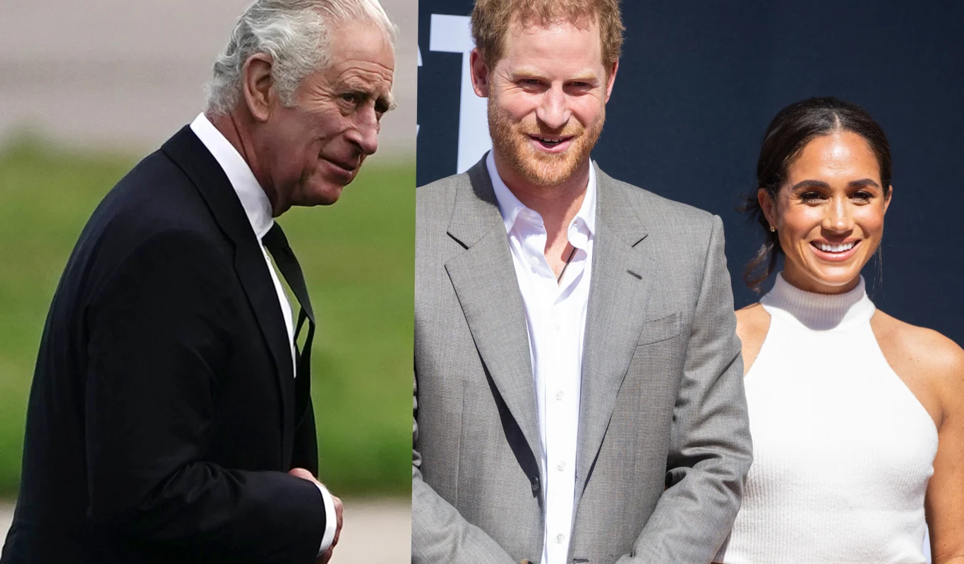 Król Karol II, Harry i Meghan Starszy mężczyzna w garniturze oraz uśmiechnięta para, mężczyzna w szarej marynarce i kobieta w białej sukience, stojąca obok niego.