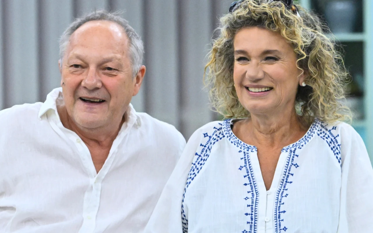 Tomasz Dedek i Joanna Trzepiecińska Śmiejący się Tomasz Dedek i Joanna Trzepiecińska, w jasnych ubraniach, na tle jasnego wnętrza.