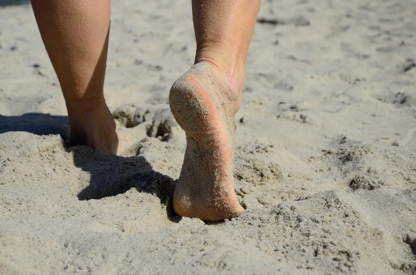 Jak wyczyścić stopy z piasku po plaży? Dzięki temu nie zabierzesz go ze sobą do domu. Stopy na plaży oblepione piaskiem.