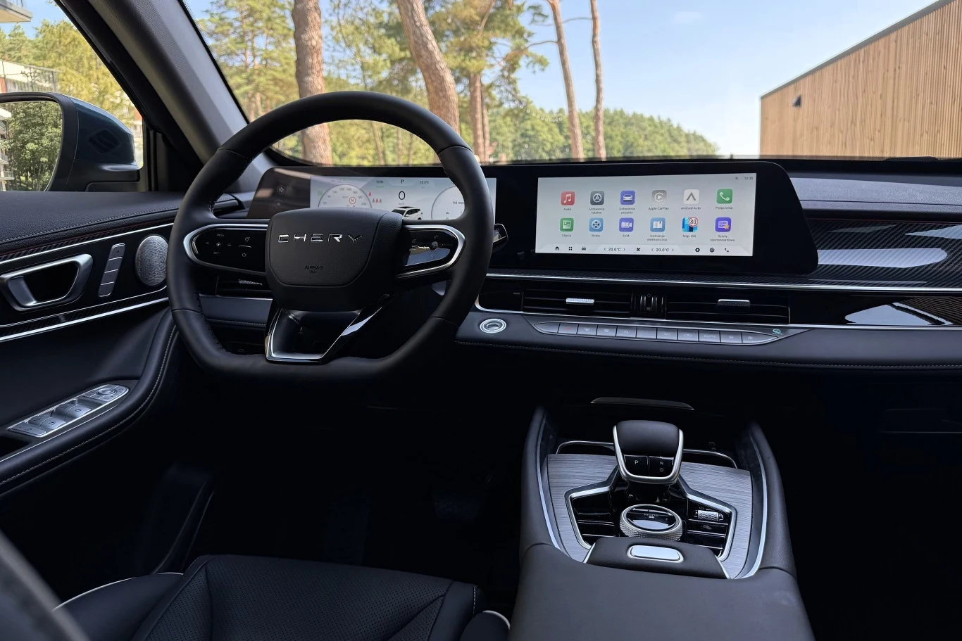Nowoczesna deska rozdzielcza z cyfrowymi wyświetlaczami, wielofunkcyjną kierownicą oraz konsolą środkową z elektronicznym wybierakiem biegów.