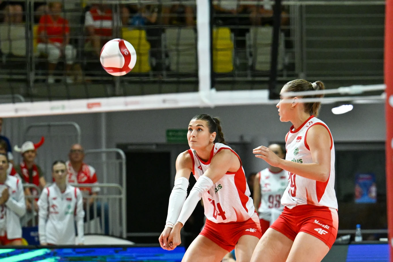 Paulina Damaske (z lewej) i Julia Orzoł podczas meczu Polska - Ukraina Siatkarki w biało-czerwonych strojach podczas dynamicznej akcji, jedna z nich przyjmuje piłkę odbiciem dolnym, skupione twarze i pełne napięcia sylwetki podkreślają sportową rywalizację.