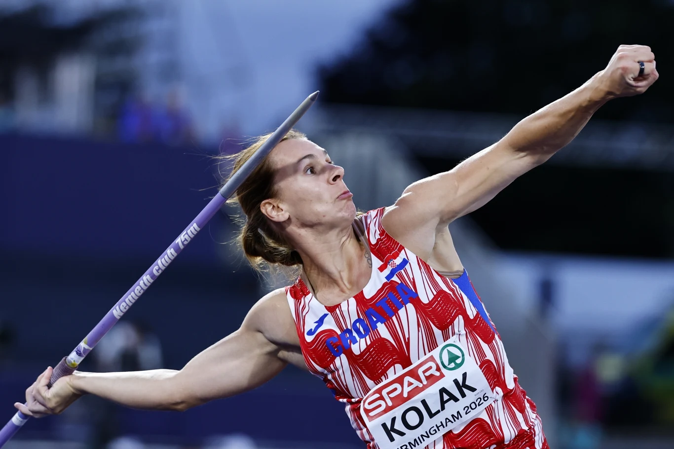 Sara Kolak Zawodniczka w stroju reprezentacji Chorwacji w dynamicznej pozie podczas rzutu oszczepem, skupienie widoczne na twarzy, oszczep uniesiony i gotowy do rzutu.