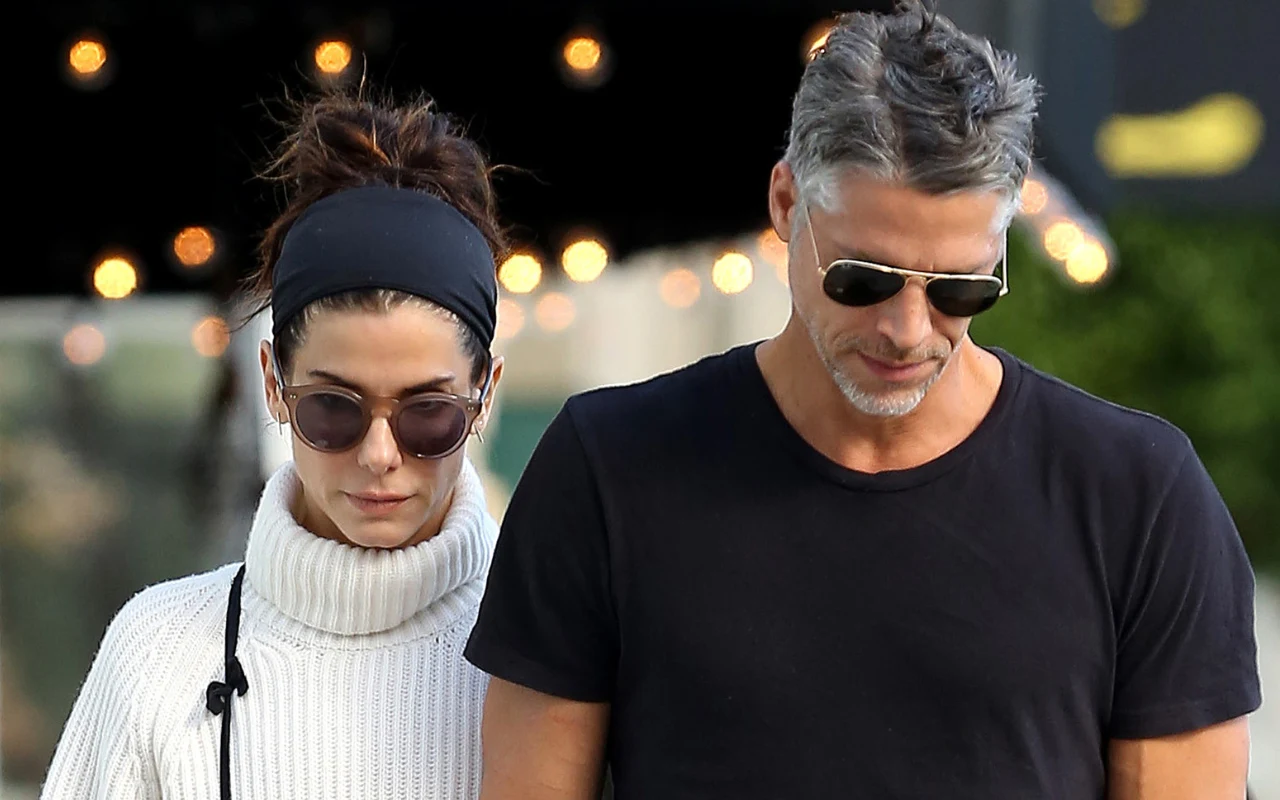 Sandra Bullock o śmierci ukochanego. Przez lata skrywała tajemnicę Sandra Bullock i Bryan Randall idą obok siebie; oboje mają okulary przeciwsłoneczne i spokojny wyraz twarzy.