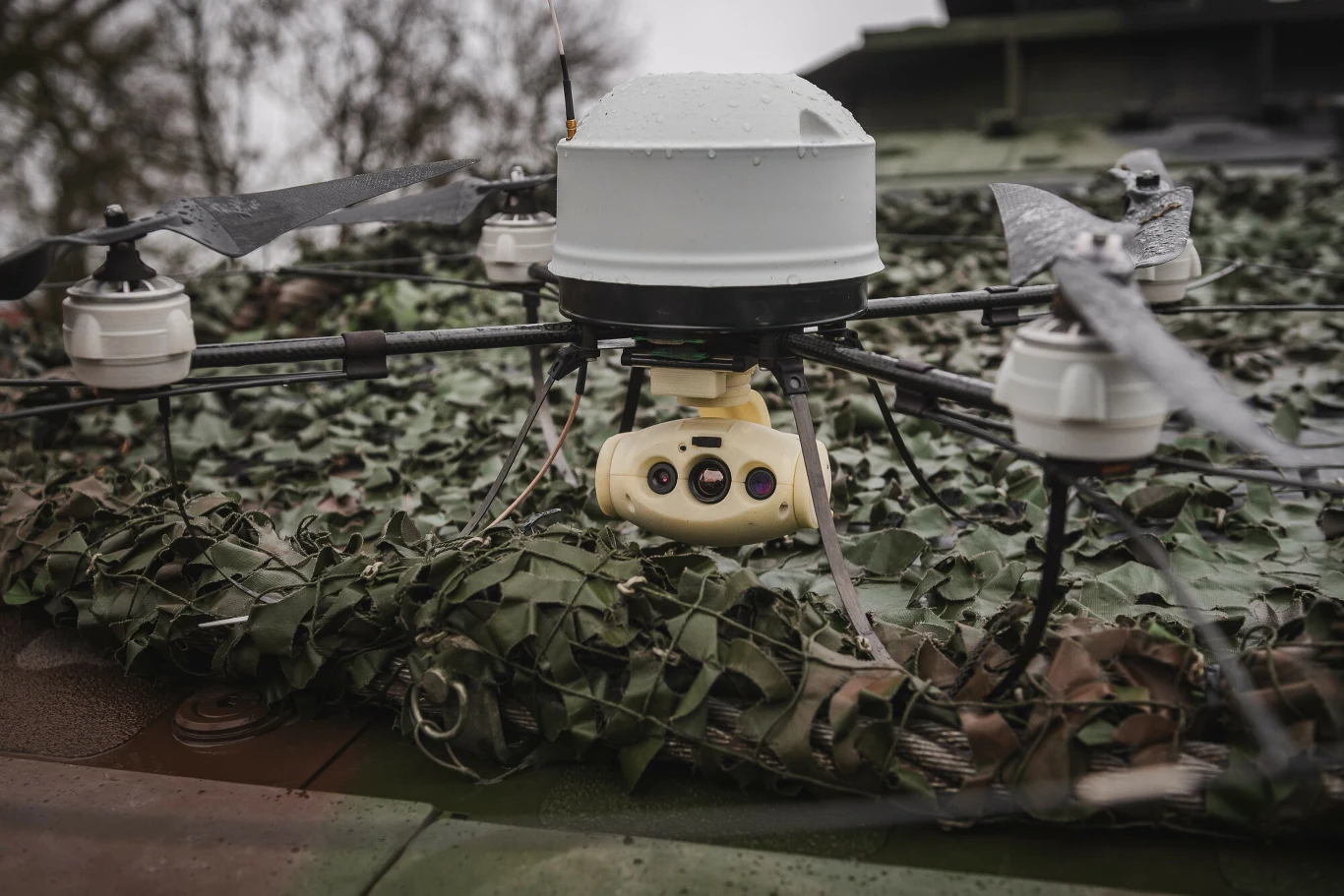 Dron wojskowy na poligonowych ćwiczeniach NATO DRAGON-24 w Korzeniewie, 5 marca 2024 r. Wojskowy dron z kamerą na pojeździe z siatką maskującą podczas ćwiczeń NATO