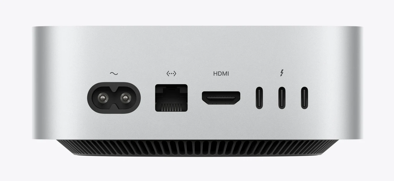 Komputer Apple Mac Mini. Panel tylnej części komputera z portem zasilania, złączem Ethernet, wyjściem HDMI oraz trzema portami USB-C.
