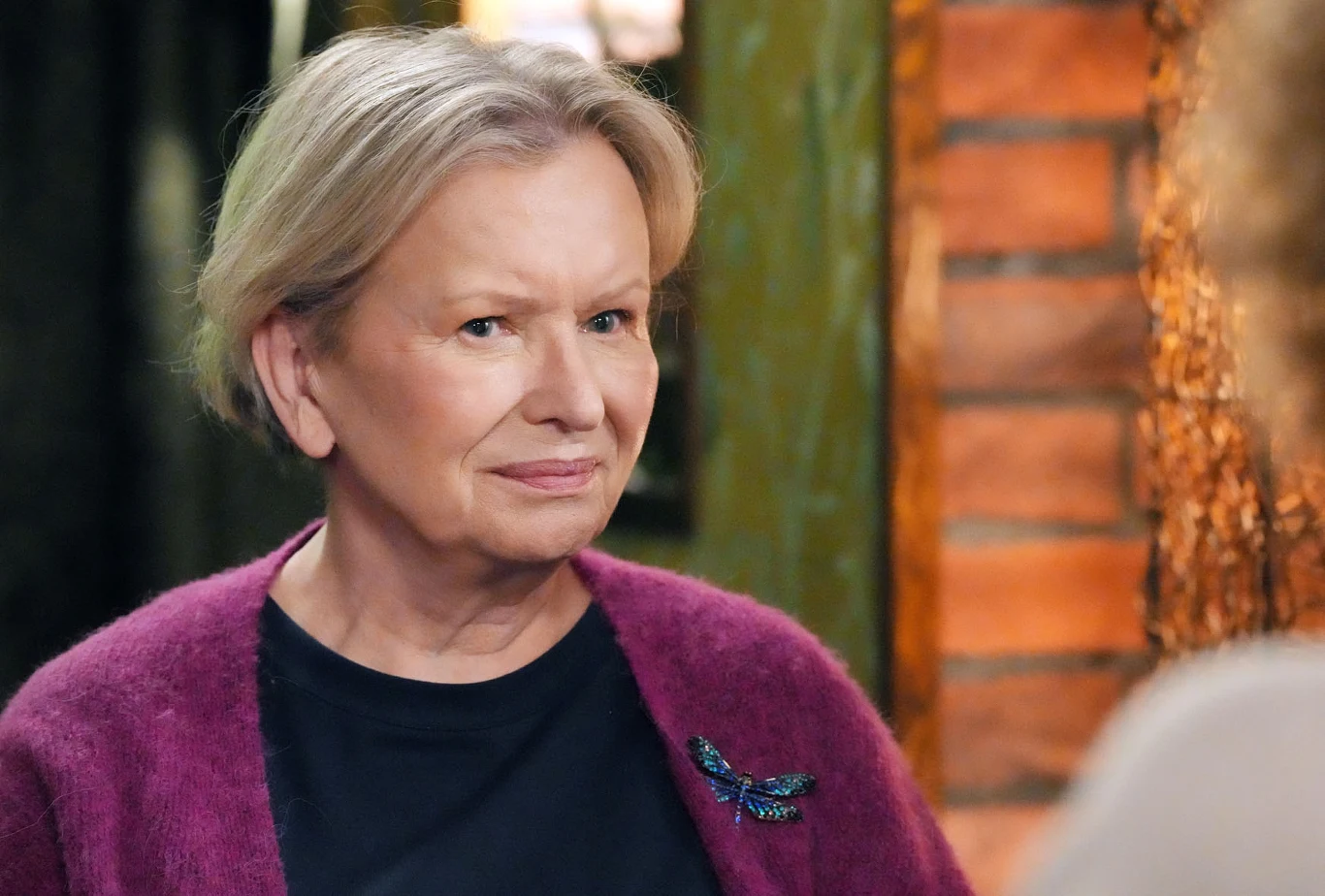 "Nie ma dnia, żebym o nich nie myślała" - wyzna Basia Józefinie Starsza kobieta o krótkich, jasnych włosach, ubrana w czarną bluzkę i fioletowy sweter z broszką w kształcie ważki, spogląda z lekkim uśmiechem.