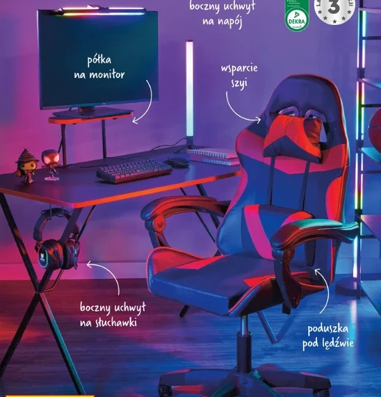 Biurko za 199 zł i krzesło za 269 zł Biurko z nowoczesnym monitorem ustawionym na specjalnej półce, klawiatura i mysz ułożone na blacie, obok ergonomiczny fotel gamingowy z poduszką pod lędźwie, wsparciem szyi, bocznym uchwytem na napój oraz uchwytem na słuchawki.