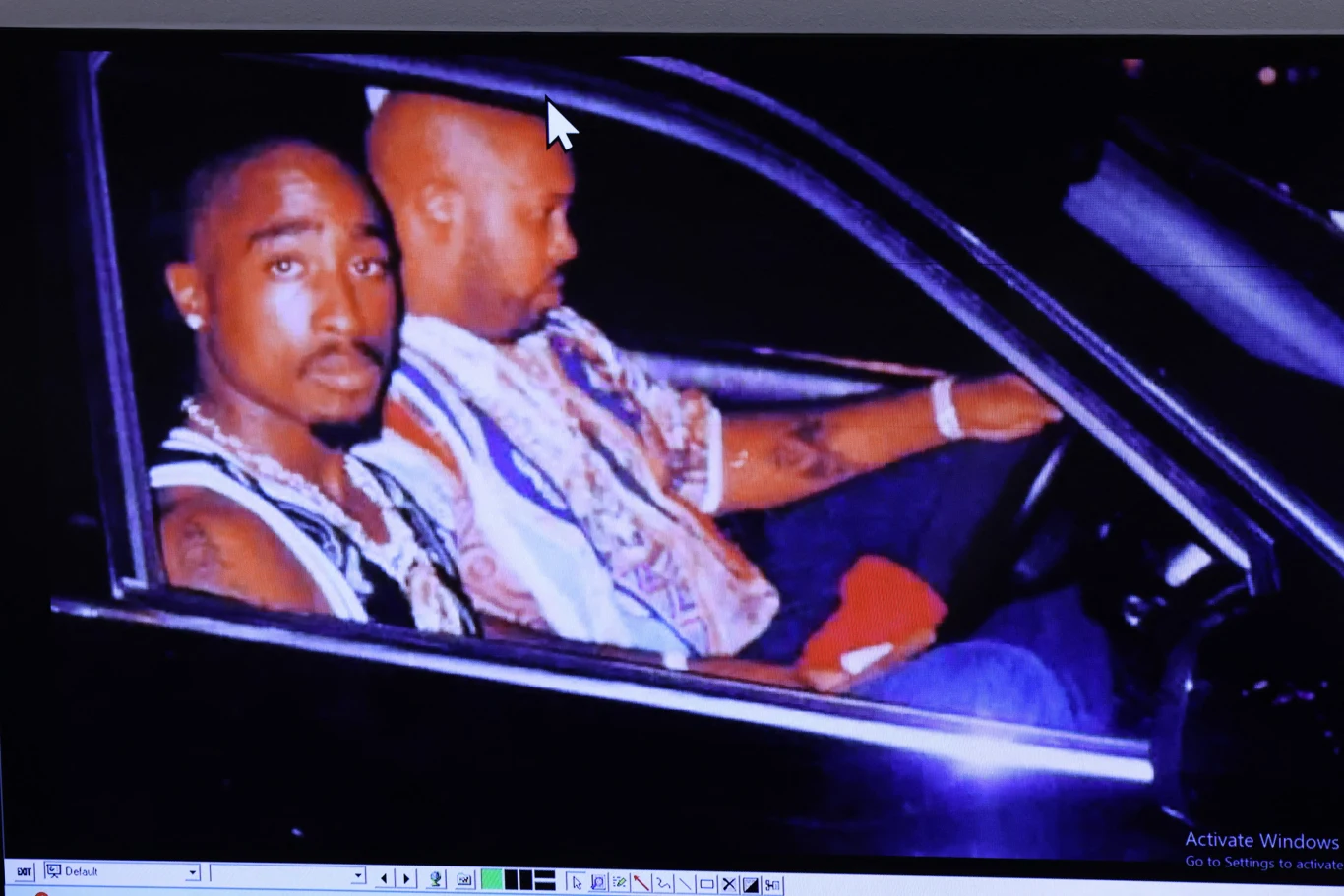 Zdjęcie Tupaca Shakura i Mariona "Suge'a" Knighta wykonane tuż przed strzelaniną w Las Vegas przez Leonarda Jeffersona przedstawione zostało ławie przysięgłych Dwóch mężczyzn siedzących w luksusowym samochodzie, jeden z nich kieruje pojazdem, drugi patrzy prosto w obiektyw kamery.