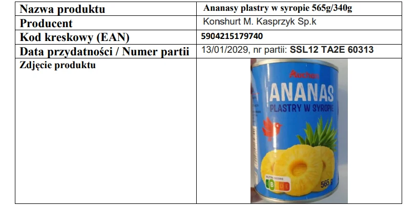 puszka z niebieską etykietą marki Auchan, na której umieszczony jest napis „ANANAS PLASTRY W SYROPIE” oraz ilustracja plastrów ananasa i połowy owocu