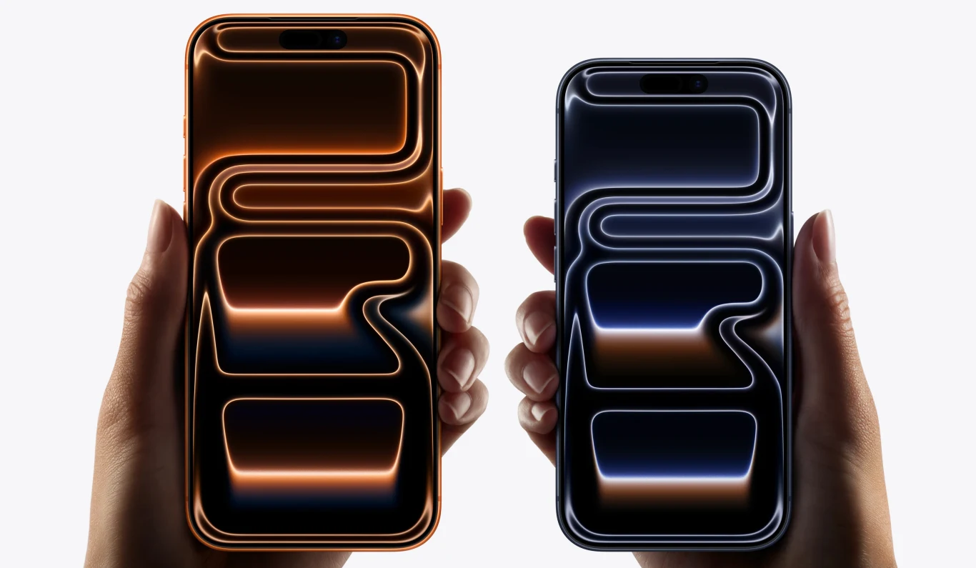 iPhone 18 Pro i Max będą droższe. O ile ceny wzrosną w Polsce? Dwie dłonie trzymają smartfony iPhone 18 Pro i Max z abstrakcyjnymi wzorami na ekranach.