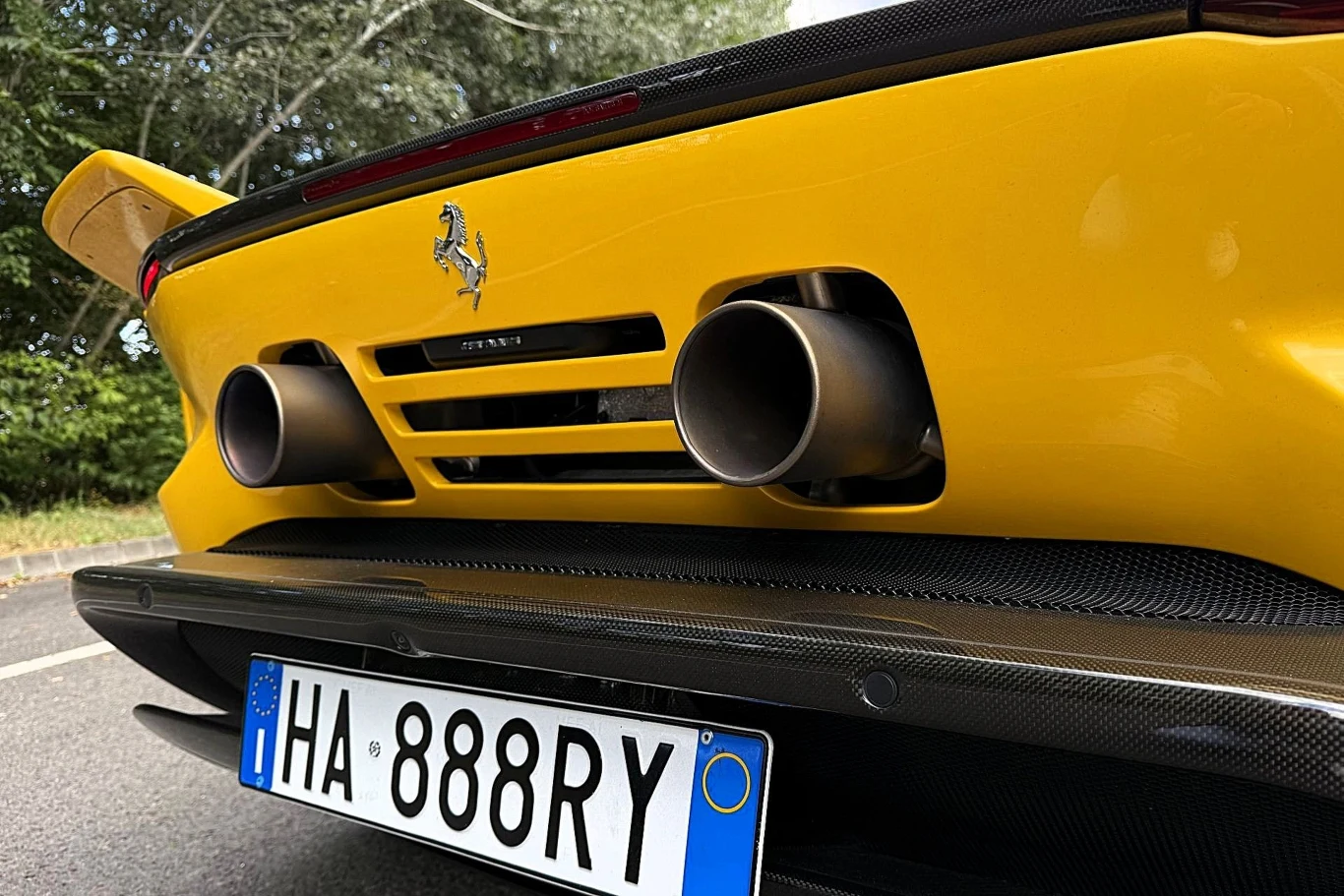 Ferrari 849 Testarossa przy prędkości 250 km/h generuje siłę docisku na poziomie 415 kg. To o 25 kg więcej niż SF90. Efektem jest m.in. większa stabilność auta. Tylny zderzak żółtego Ferrari z charakterystycznym logo producenta, dwiema dużymi końcówkami wydechu i włoską tablicą rejestracyjną.