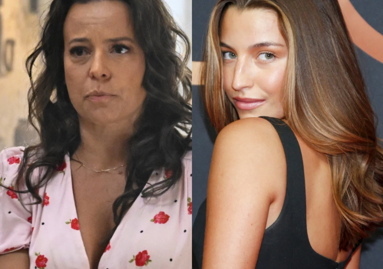 Anna Mucha, Julia Wieniawa Anna Mucha w różowej sukience w róże oraz Julia Wieniawa w czarnej sukni z odkrytymi plecami pozują razem do zdjęcia.