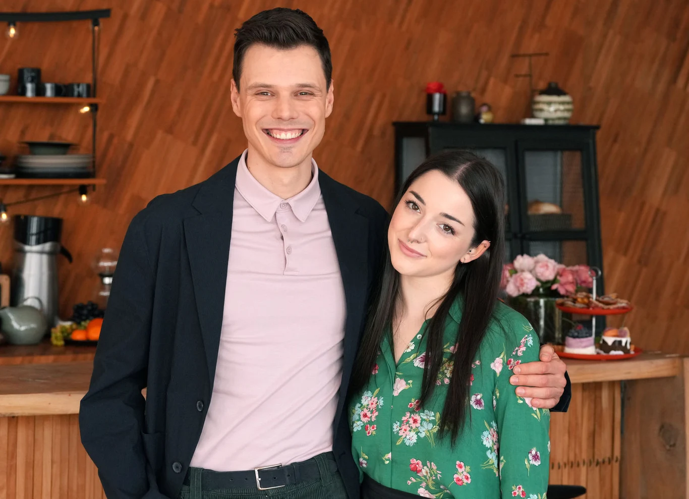 Kacper (Jakub Szlachetka) i Luiza (Julia Zielińska) zostaną parą? Kacper i Luiza stoją razem w nowoczesnej kuchni, on w marynarce, ona w kwiecistej zielonej koszuli.