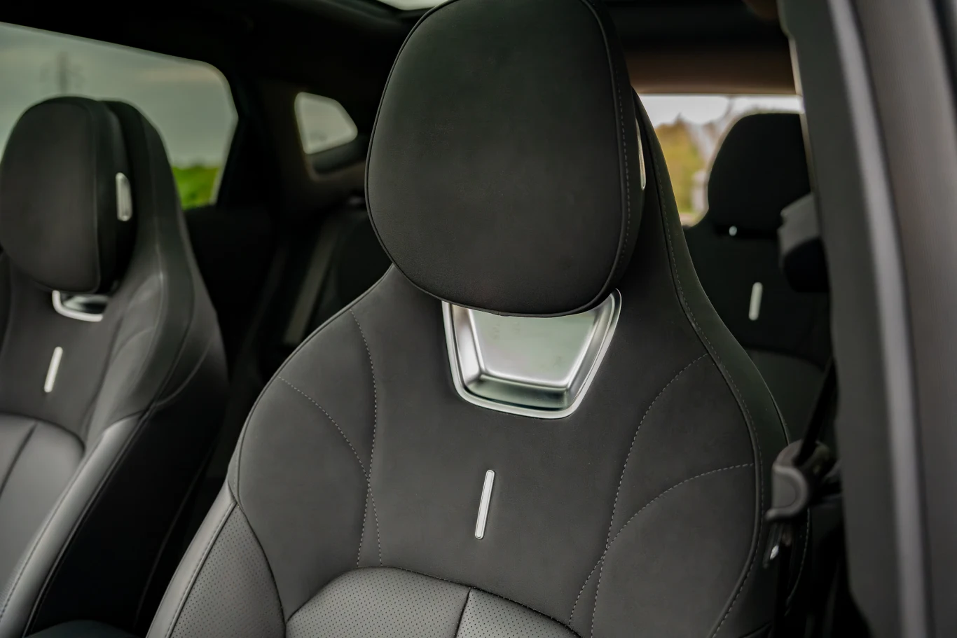 Omoda 7 w wersji Luxury ma skórzaną tapicerkę łączoną z zamszową Czarne, nowoczesne fotele samochodowe z eleganckim przeszyciem i chromowanymi detalami na zagłówkach.