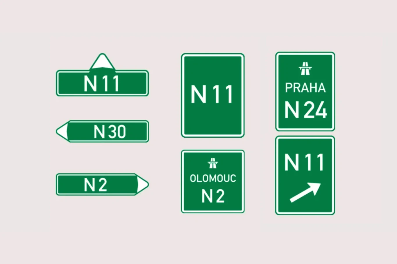 Wzór nowego oznakowania. Zielone znaki drogowe z białymi napisami informujące o numerach i kierunkach tras, w tym tablice wskazujące na N11, N24 w kierunku Pragi, N30, N2 oraz Olomouc.