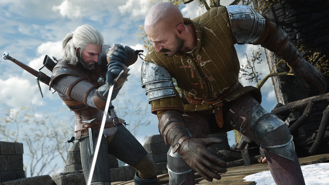 Wiedźmin 3: Dziki Gon Remaster Dwóch mężczyzn w średniowiecznych zbrojach walczy ze sobą na miecze na tle kamiennej konstrukcji, jeden z nich wyprowadza cios, a drugi unika uderzenia.