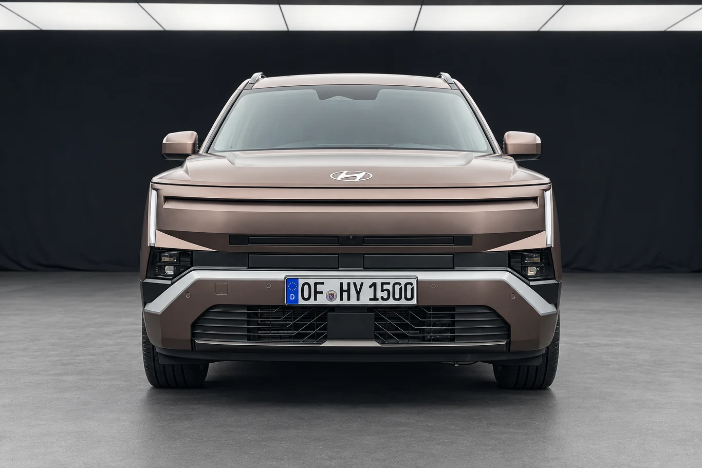 Hyundai Tucson Nowoczesny SUV w kolorze brązowym o geometrycznych liniach nadwozia, z charakterystycznym przodem wyposażonym w wąskie reflektory LED i masywny grill, widziany na tle ciemnego, minimalistycznego otoczenia.