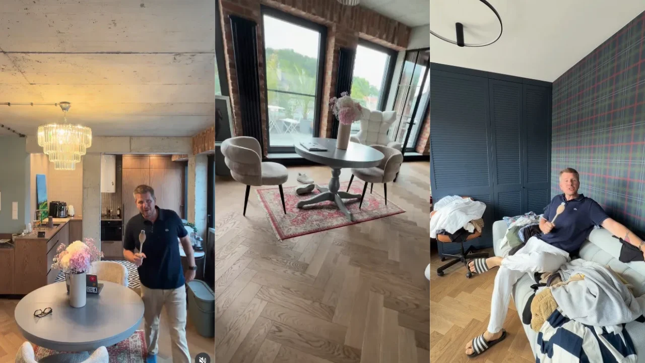 Nowoczesny apartament z kuchnią otwartą na salon, ozdobnym żyrandolem, okrągłym stołem z bukietem kwiatów, dużymi oknami oraz osobą stojącą i osobą siedzącą na łóżku w jasnym, wygodnym wnętrzu.