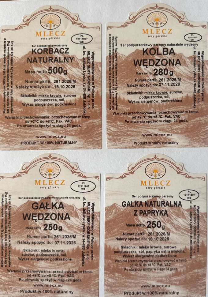 Cztery etykiety produktów mleczarskich marki MLECZ z nazwami: korbacz naturalny, kolba wędzona, gałka wędzona oraz gałka naturalna z papryką, każda zawiera szczegółowe informacje o masie produktu, składzie i producencie, utrzymane w jednolitej szacie g...