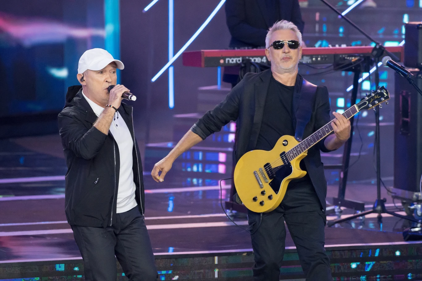 Impreza na rynku w Wałbrzychu. Na scenie pojawi się m.in. zespół De Mono. Koncert zespołu De Mono na scenie, wokalista śpiewa, gitarzysta gra na gitarze elektrycznej, kontekst imprezy w Wałbrzychu.