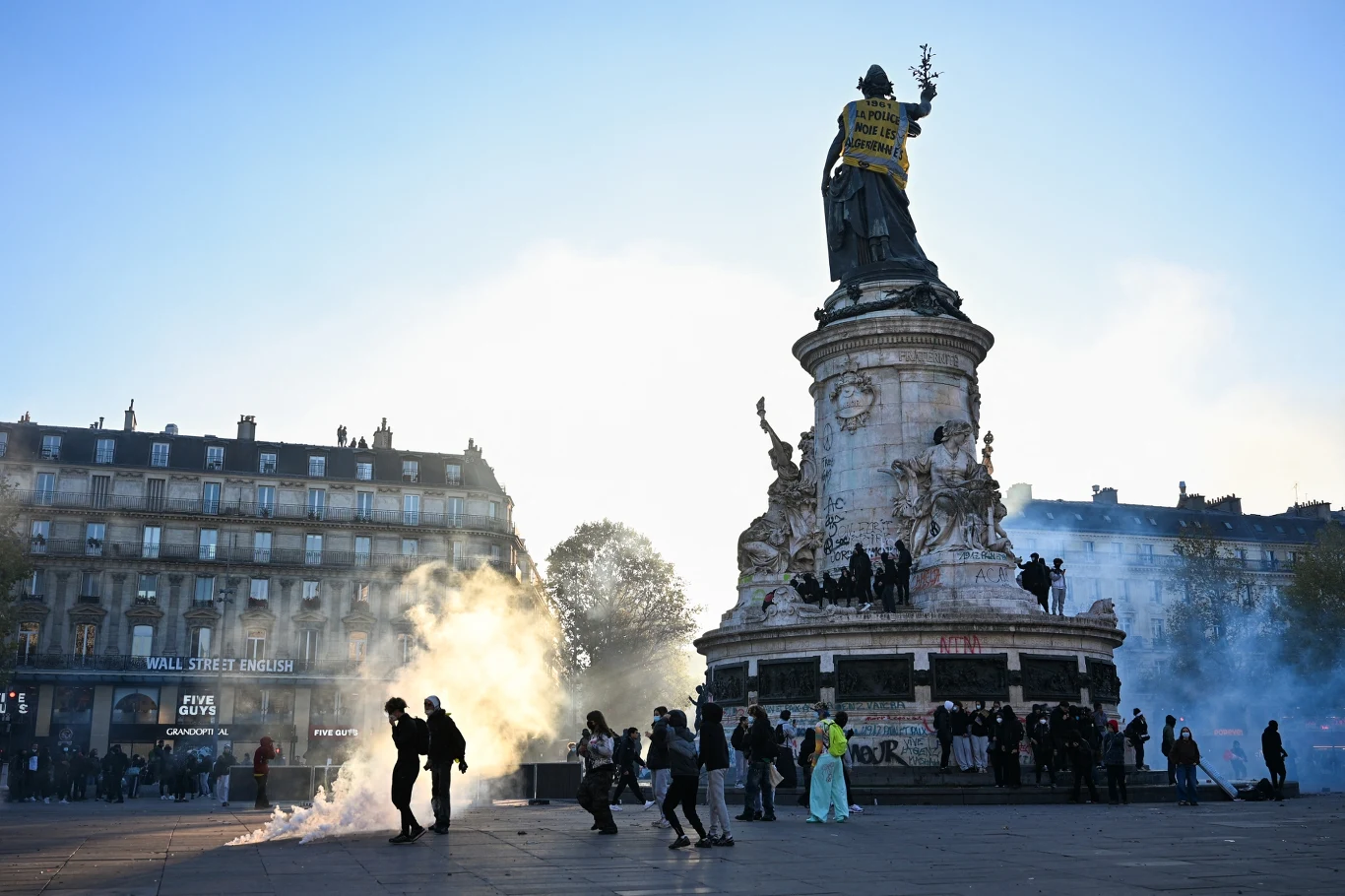 Wymowne zdjęcie spod pomnika Republiki w Paryżu. Francja po fali gwałtownych zamieszek. Protestujący wokół pomnika Republiki w Paryżu. Na placu unosi się gaz łzawiący, a monument pokrywają graffiti.