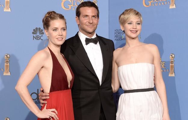Amy Adams, Bradley Cooper i Jennifer Lawrence podczas rozdania Złotcyh Globów 2014 /AFP