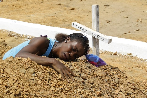 Kobieta na grobie jednej z ofiar eboli /AHMED JALLANZO  /PAP/EPA