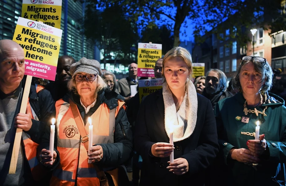 People hold a candlelight vigil Thursday in London for the 39 people who died in a truck container