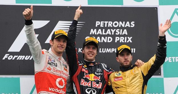 Najlepsi kierowcy GP Malezji: Jenson Button (z lewej), Sebastian Vettel i Nick Heidfeld (z prawej) /AFP