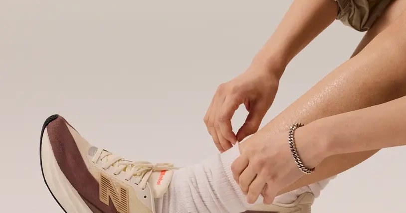 Osoba podwijająca skarpetki i mająca na sobie buty do biegania New Balance Rebel V5 /materiały promocyjne