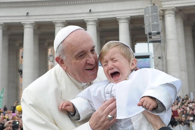 Papież błogosławi dziecko w papieskich szatach /ANSA/OSSERVATORE ROMANO /PAP/EPA