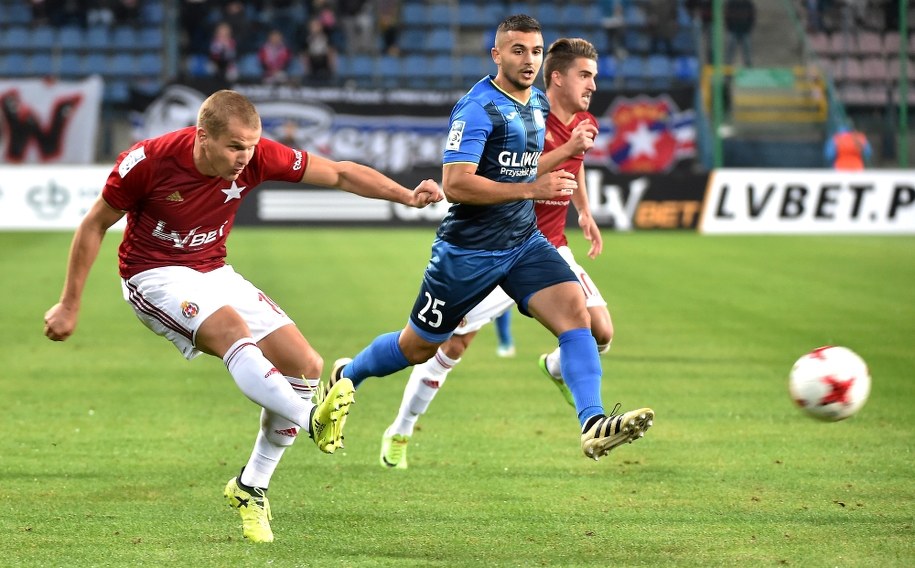 Piłkarz Wisły Kraków Tomasz Cywka i Aleksandar Sedlar z Piasta Gliwice podczas meczu 9. kolejki o mistrzostwo piłkarskiej Ekstraklasy w Krakowie /Jacek Bednarczyk /PAP