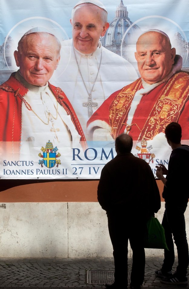 Plakat z wizerunkami Jana Pawła II (po lewej), Jana XXIII (po prawej) i Franciszka w Rzymie /CLAUDIO PERI /PAP/EPA